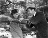 Katharine Hepburn Leaning on Tree with a Man Talking in Black and White Photo Print - Item # VARCEL699199