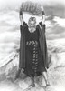 Charlton Heston Raising the Ten Commandments, wearing Red Dress with Slippers - A film still from The Ten Commandments Photo Print - Item # VARCEL699268