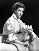 Kathryn Grayson on Silk Top Sitting While Holding Flowers Photo Print - Item # VARCEL699362