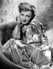 Virginia Grey sitting on a Chair in Shiny Dress Photo Print - Item # VARCEL699453