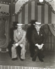 Bob Hope Seated with Man on Stage wearing Tuxedo with Hat Photo Print - Item # VARCEL700035