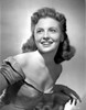 Joan Leslie on a Silk Dress sitting and smiling Photo Print - Item # VARCEL701367