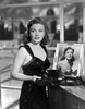 Joan Leslie on a Dress With Her Own Portrait in a Frame Photo Print - Item # VARCEL701403