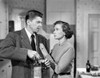 She's Working Her Way Through College Man in Suit Talking with Woman Photo Print - Item # VARCEL701634