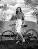 Dorothy Malone on a Printed Top and Holding a Bicycle Photo Print - Item # VARCEL701725