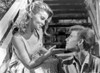 Bye Bye Birdie Lady in Printed Dress Talking to a Man in Polo Photo Print - Item # VARCEL701764