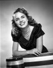 Terry Moore Leaning and smiling Portrait in Classic Photo Print - Item # VARCEL702337
