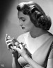 Patricia Neal Holding Perfume in Classic Photo Print - Item # VARCEL702522