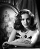 Joan Newton Leaning on a Table, wearing a Strapless Black Dress in Portrait Photo Print - Item # VARCEL702606