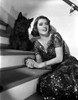 Barbara O'Neil on Embroidered Dress posed with Dog Photo Print - Item # VARCEL702705
