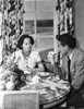 Merle Oberon sitting and smiling while Talking to a Man Photo Print - Item # VARCEL702824