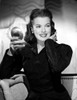 Janis Paige sitting on a Couch in Black Long Sleeve Shirt with Right Hand Holding a Mirror Photo Print - Item # VARCEL702900
