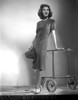Jean Parker Posed in Grey Short Sleeve Linen Dress and White Shoes with Hands on a Wheeled Table Photo Print - Item # VARCEL702932