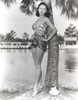 Rhonda Fleming leaning on a tree trunk in a bikini Photo Print - Item # VARCEL689123