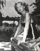 Rhonda Fleming on a sun lounger wearing a one piece swimsuit Photo Print - Item # VARCEL689134