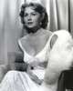 Rhonda Fleming sitting on a Chair wearing a White Gown Photo Print - Item # VARCEL689157