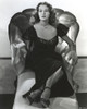Rhonda Fleming Relaxing on a Couch wearing a Black Gown Photo Print - Item # VARCEL689163