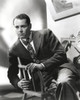 Henry Fonda Leaning on a Wooden Chair in Suit and Tie Photo Print - Item # VARCEL689303
