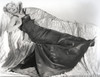 Joan Fontaine Lying on a Couch wearing a Black Gown and Touching Her Breast Photo Print - Item # VARCEL689342