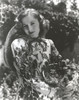 Joan Fontaine holding flowers outdoors Photo Print - Item # VARCEL689386