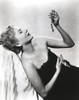 Joan Fontaine Relaxing on a Couch wearing Black Gown Photo Print - Item # VARCEL689407