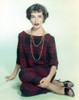 Phyllis Kirk Seated on Floor in Red Checkered Dress Portrait with White Background Photo Print - Item # VARCEL689697