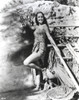 Dorothy Lamour wearing a wrap dress next to a lean to Photo Print - Item # VARCEL689902