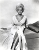 Janet Leigh sitting on the Bed in White Silk V-Neck Long Sleeve Gathered Bodice Long Dress with Legs Crossed and Hands Rest on the Side Photo Print - Item # VARCEL690187