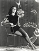 Janet Leigh Posed on a Chair in Black Velvet Short Skirt Sleeveless Dress and White Leather Belt with Legs Crossed and Left Arm Rest on the Top Rail Photo Print - Item # VARCEL690198