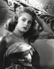 Janet Leigh sitting on the Couch in Strapless Gatherer Bodice Shoulder Dress with Right Hand on the Head Photo Print - Item # VARCEL690220