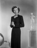 Myrna Loy standing in Long Sleeve Dress Photo Print - Item # VARCEL690569
