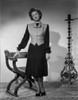 Myrna Loy standing in Long Sleeve Dress with Vest Photo Print - Item # VARCEL690573