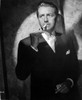 Paul Henried standing in Black Suit With Cigarette Photo Print - Item # VARCEL692001