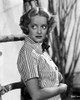 Bette Davis Posed Looking Up to the Right with Hands on the Tummy in Striped Short Sleeve Collar Shirt Photo Print - Item # VARCEL692823