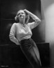Bette Davis Posed Looking Up and Hand on the Head in Long Sleeve Knitted Shirt and Black Silk Long Skirt Photo Print - Item # VARCEL693047