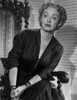 Bette Davis Seated on Chair with Hands Together in Black V-Neck Folded Long Sleeve Dress and Bracelet with Marcel Wave Hair Photo Print - Item # VARCEL693114