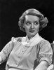 Bette Davis Seated while Looking to the Left in White High Neck Folded Short Sleeves Shirt Photo Print - Item # VARCEL693184