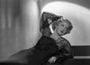 Bette Davis Reclining on the Table with Hand on the Head in Black Sheer Long Sleeve Dress Photo Print - Item # VARCEL693195