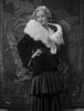 Bette Davis Posed Hand on the Waist in White Fur Boa in Black Long Sleeve Dress and Ruffled Skirt Photo Print - Item # VARCEL693254