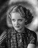 Bette Davis Portrait Looking Serious with Waved Hairstyle in White Polka Dot Short Sleeved Shirt Photo Print - Item # VARCEL693289