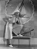 Bette Davis Posed on a Bench with Head Leaning on the Hand in Sleeveless Shirt and White with White Flat Shoes Photo Print - Item # VARCEL693357