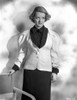 Bette Davis Posed with Hand Touching the Chair in Black Collar Shirt and White Mutton Long Sleeve Vest Photo Print - Item # VARCEL693391