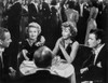 Greta Garbo Chatting with Friends on a Table Photo Print - Item # VARCEL693392