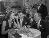 Greta Garbo with Two Men on Table Photo Print - Item # VARCEL693396