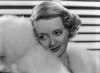 Bette Davis Portrait with Leaning to the Right in White Fur Boa and White Fur Pelted Dress Photo Print - Item # VARCEL693406