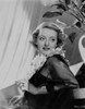Bette Davis Portrait Lying Back on a Table in Sunflower Garland and Black Linen Lace Long Sleeves Photo Print - Item # VARCEL693441