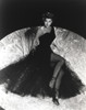 Ava Gardner posed in Long Black Gown with Stockings and Stiletto Photo Print - Item # VARCEL693756