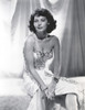 Ava Gardner on an Embroidered Dress and sitting Pose Photo Print - Item # VARCEL693937