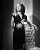 Virginia Belmont on a Printed Dress standing and Leaning on Chair Photo Print - Item # VARCEL694000