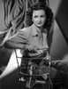 Joan Bennett sitting and Crossing Legs Portrait Photo Print - Item # VARCEL694094